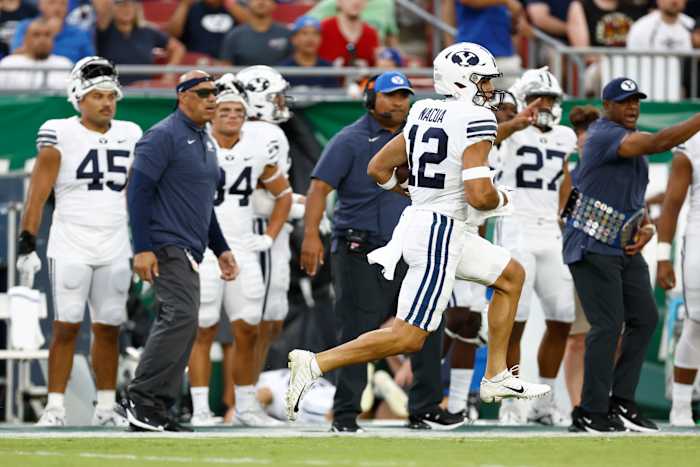 Brigham Young Cougars wide receiver Puka Nacua (12) runs the ball in for a touchdown against the South Florida Bulls during the first half at Raymond James Stadium.